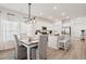 Bright, open-concept kitchen featuring modern appliances, granite countertops, and seamless flow into the dining area at 136 Post Mill Dr, Summerville, SC 29485