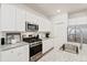 Modern kitchen featuring granite countertops, stainless steel appliances, and ample white cabinetry at 136 Post Mill Dr, Summerville, SC 29485