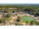 An aerial view of a neighborhood, featuring well-maintained homes, a pond, and lush green landscaping at 1425 Lagoon Park Cir, Mount Pleasant, SC 29466