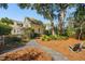 Lush backyard with a gravel path, mature trees, and inviting outdoor seating, perfect for relaxation at 1425 Lagoon Park Cir, Mount Pleasant, SC 29466