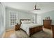 This primary bedroom features a ceiling fan, wooden furniture, neutral walls, and natural light for a cozy and relaxing retreat at 1425 Lagoon Park Cir, Mount Pleasant, SC 29466