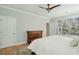 Bedroom with hardwood floors, a ceiling fan, dresser and light-filled windows with blinds at 1425 Lagoon Park Cir, Mount Pleasant, SC 29466