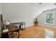 Sunlit bedroom featuring hardwood floors, neutral walls, and a desk setup for work or study at 1425 Lagoon Park Cir, Mount Pleasant, SC 29466