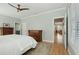 Bright bedroom with hardwood floors, ceiling fan, and ensuite bathroom and hallway access at 1425 Lagoon Park Cir, Mount Pleasant, SC 29466