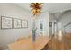 A dining room with a wood table and seating is enhanced by artwork and a view into the home's entryway at 1425 Lagoon Park Cir, Mount Pleasant, SC 29466
