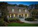 Inviting two-story home with a covered porch, manicured landscaping, and warm exterior lighting at 1425 Lagoon Park Cir, Mount Pleasant, SC 29466
