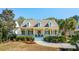 Charming yellow home featuring a covered front porch, dormer windows and mature landscaping at 1425 Lagoon Park Cir, Mount Pleasant, SC 29466