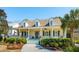 Charming yellow home featuring a covered front porch, dormer windows and mature landscaping at 1425 Lagoon Park Cir, Mount Pleasant, SC 29466
