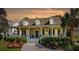 Charming yellow home featuring a covered front porch, dormer windows and mature landscaping at 1425 Lagoon Park Cir, Mount Pleasant, SC 29466