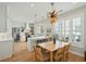 Well-lit kitchen and breakfast nook with island, barstool seating, and modern light fixture at 1425 Lagoon Park Cir, Mount Pleasant, SC 29466