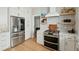 Gourmet kitchen features stainless steel appliances, white cabinets, and open shelving for a modern and functional space at 1425 Lagoon Park Cir, Mount Pleasant, SC 29466