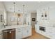 Open-concept kitchen with stainless steel appliances, white cabinets, and adjacent dining area for a seamless entertaining experience at 1425 Lagoon Park Cir, Mount Pleasant, SC 29466