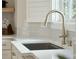 The kitchen sink has a brushed nickel faucet and fixtures, white countertops, and is lit by natural light at 1425 Lagoon Park Cir, Mount Pleasant, SC 29466