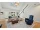 Sunlit living room boasts vaulted ceilings, a cozy sectional, and beautiful hardwood floors at 1425 Lagoon Park Cir, Mount Pleasant, SC 29466
