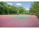 Well-maintained tennis courts with shaded seating area nestled among mature trees, ideal for active recreation at 1425 Lagoon Park Cir, Mount Pleasant, SC 29466