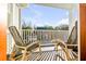 Balcony with black wicker chairs and views of trees and houses at 146 S Battery St, Charleston, SC 29401