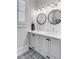 Bright bathroom with double vanity, undermount sinks, shiplap accents, and designer fixtures, offering a modern and stylish space at 146 S Battery St, Charleston, SC 29401