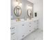 Elegant bathroom featuring double sinks, quartz counters, shiplap walls, and gold hardware at 146 S Battery St, Charleston, SC 29401