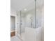 Spacious bathroom showcasing a glass-enclosed shower, white marble tile, and modern fixtures, with a view into another room at 146 S Battery St, Charleston, SC 29401