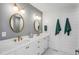 Elegant bathroom featuring double sinks, quartz counters, shiplap walls, and gold hardware at 146 S Battery St, Charleston, SC 29401