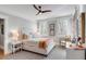 Bright bedroom featuring hardwood floors, stylish rugs, plantation shutters, and a ceiling fan at 146 S Battery St, Charleston, SC 29401