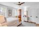 Comfortable bedroom with hardwood floors, stylish rugs, plantation shutters, and a ceiling fan at 146 S Battery St, Charleston, SC 29401