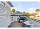 Outdoor deck with a grill, seating, and a view of the neighborhood at 146 S Battery St, Charleston, SC 29401