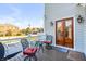 Outdoor seating area on a home's deck with nice views and a wooden double-door entrance at 146 S Battery St, Charleston, SC 29401