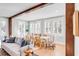 Sunlit dining area features shuttered windows, a modern chandelier, and seating for eight at 146 S Battery St, Charleston, SC 29401