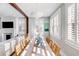 Elegant dining space with shuttered windows, hardwood floors, and an adjacent living area at 146 S Battery St, Charleston, SC 29401