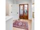 Inviting entryway with decorative rug, a glass paneled door, and white trim at 146 S Battery St, Charleston, SC 29401
