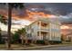 Charming two-story home with a double porch and professionally landscaped front yard with a gorgeous sunset at 146 S Battery St, Charleston, SC 29401