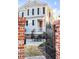 Brick-lined gate creates a welcoming entrance to this home's outdoor space and patio area at 146 S Battery St, Charleston, SC 29401
