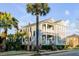 Charming two-story home with a double porch and professionally landscaped front yard with a beautiful palm tree at 146 S Battery St, Charleston, SC 29401