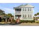 Charming two-story home with a double porch, landscaped yard, and brick stairs leading to the front door at 146 S Battery St, Charleston, SC 29401