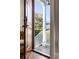 Inviting front door with wood frame and view to the porch with white railing and wood floor at 146 S Battery St, Charleston, SC 29401