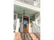 Charming home featuring a wooden front door with glass, black hardware, and black hanging lanterns at 146 S Battery St, Charleston, SC 29401