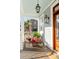 Inviting front porch with potted flowers, a hanging lantern, and views of the neighborhood at 146 S Battery St, Charleston, SC 29401