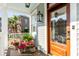 Beautiful porch with potted plants, hanging lanterns and a glass-paned wooden front door at 146 S Battery St, Charleston, SC 29401