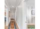 Hallway featuring wood floors, white walls, and colorful rugs at 146 S Battery St, Charleston, SC 29401