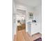 Bright hallway leading to an open-concept living space and kitchen with white plank walls at 146 S Battery St, Charleston, SC 29401