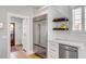 Modern kitchen details include a stainless steel refrigerator, custom cabinetry, and open shelving at 146 S Battery St, Charleston, SC 29401