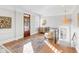 Upstairs landing with wood floors, decorative rug, and a stylish pendant light fixture at 146 S Battery St, Charleston, SC 29401