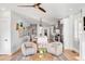 Sunlit living room and kitchen area showcases stylish decor, a large island, and warm hardwood floors at 146 S Battery St, Charleston, SC 29401