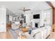 Spacious open-concept living area with a kitchen island, modern fireplace and comfortable seating at 146 S Battery St, Charleston, SC 29401