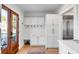 Mudroom offering ample storage with white cabinets and brass hardware at 146 S Battery St, Charleston, SC 29401