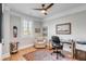 Cozy home office featuring hardwood floors, a modern desk, a comfortable chair, and a unique decorative skateboard at 146 S Battery St, Charleston, SC 29401
