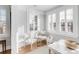 Bright sitting room featuring three white chairs, natural light and white walls at 146 S Battery St, Charleston, SC 29401