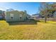 Large backyard with well-maintained lawn, trees and fence featuring patio and deck with outdoor furniture at 1466 Arrow Wind Ter, Charleston, SC 29414