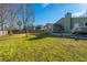 Expansive green backyard featuring a home with a chimney and an inviting patio area for relaxation and entertaining at 1466 Arrow Wind Ter, Charleston, SC 29414